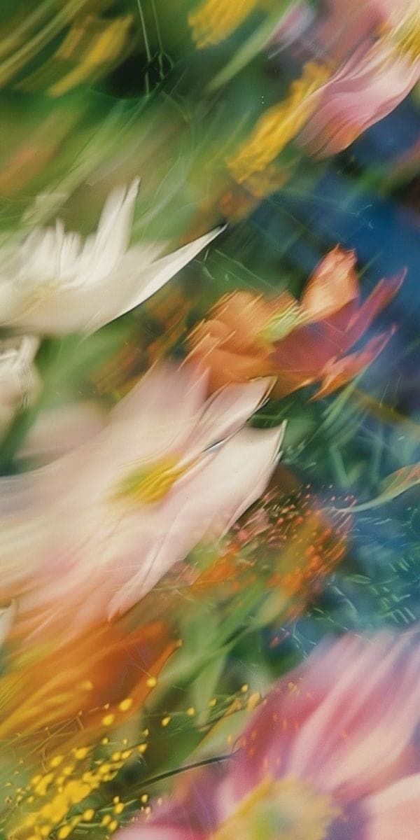 Pink, white and orange flowers blurred in motion